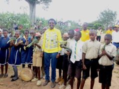 Minister Muhwezi hailed for organizing Community Barazas. Minister Muhwezi pose for a group with Schooling children carrying guns made of out of local materials after closing 5 day community baraza meetings in Buhunga sub-county over the weekend Rukungiri district.Photo by Pearlnews.