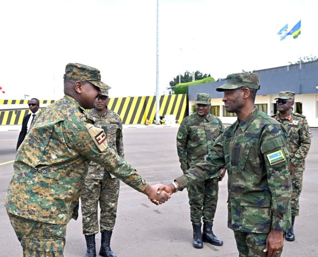 CDF General Muhoozi shaking hand withGeneral Mubarakh Muganga, the Chief of Defence Staff of the Rwanda Defence Force and other RDF Generals. photo by UPDF Press Team.
